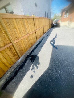 Cracked deteriorated asphalt driveway